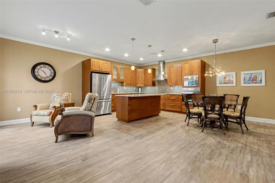 West Lake Village, Corner townhouse featuring a one-car garage and a private in-ground jacuzzi. The property showcases an open floor plan with an updated kitchen, complete with granite countertops, a wall oven, and a microwave, alongside modernized bathrooms. Significant updates include a new roof in 2020, impact windows and doors in 2025, and a new AC unit installed in 2021. The home is elegantly appointed with wood flooring throughout and is conveniently located less than a mile from the renowned Hollywood Beach and Broadwalk. Residents benefit from 24-hour security for enhanced peace of mind and enjoy access to exceptional community amenities, including a heated pool with a chiller, a relaxing hot tub, and state-of-the-art gym equipment. The community also offers tennis, pickleball, and basketball courts, a tot lot, and a community room with a kitchen for gatherings. The neighborhood is further enhanced by newly paved roads and is surrounded by four picturesque lakes. This is an exceptional opportunity to reside in a vibrant and well-equipped community.