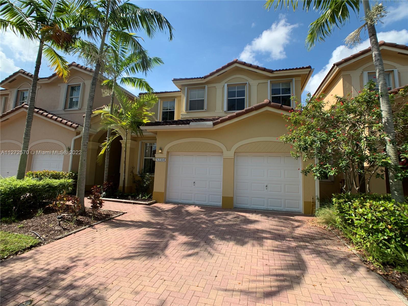 This gorgeous 4/3 townhouse with 2 car garage features an open floor plan, high volume ceilings, upgraded kitchen with granite counters, a paved patio area perfect for entertaining, accordion shutters and much more! Large master suite includes walk in closet and spacious shower/ Roman tub combination. One bedroom on first floor perfect for In-Laws and guests. Kendall Breeze is professionally maintained community offering security patrol, pool and is easy access to Turnpike! This particular property is strategically located just steps to the clubhouse/pool and with plentiful street parking in front. Easy to show.