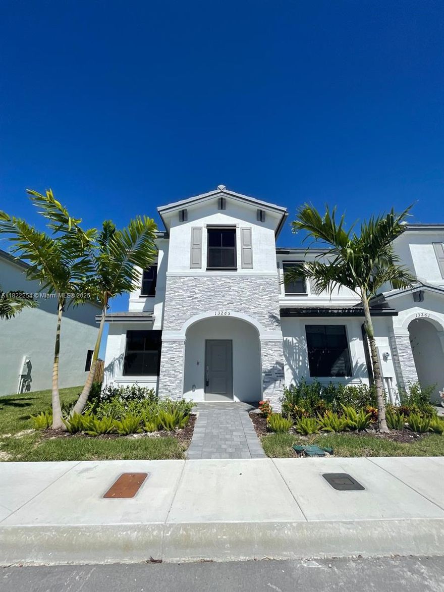 Move into this LIKE-NEW 2-STORY CORNER HIGH TECH TOWNHOME — fully refreshed & move-in ready! 3BR/2.5BA, meticulously maintained w/ brand-new flooring, sleek kitchen w/ SS appliances, quartz counters, spacious walk-in closets, & private fenced backyard w/ no rear neighbors. Corner unit = extra privacy, abundant natural light & no side neighbors. Live smart: Ring Alarm video, smart thermostat, FIBER INTERNET. Upgraded Washer/dryer included. GATED COMMUNITY w/ clubhouse, fitness center, resort-style pool, kids' park & 24/7 security access. Prime location — just 5 min to Homestead Air Reserve Base, Amazon, Baptist Health, FedEx, Homestead Speedway & Turnpike.