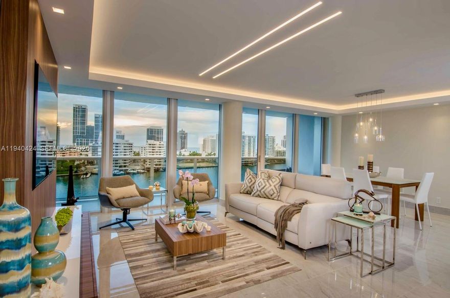 Magnificent top-floor residence in Miami Beach (NoBe) offering breathtaking panoramic views of the ocean, Intracoastal, and bay from the prestigious King Cole Building. Floor-to-ceiling impact glass walls flood the home with natural light, showcasing its iconic historic MiMo architecture.
Fully renovated, this modern waterfront home delivers a serene, resort-style lifestyle just a 15-minute walk to the beach. Designed for comfort and entertaining, it features an expansive open living area and a large balcony with stunning bay views. Designer lighting, elegant finishes, dual vanities, a beautifully organized walk-in closet, and thoughtful upgrades throughout complete this exceptional residence.
The home also includes a rare oversized laundry room, equipped with washer, dryer, utility sink, built-in ironing board, and extensive storage closets for cleaning supplies. While many units convert this space into a den or office, this residence preserves it as a dedicated laundry/utility room.
Parking is generous, with one assigned space for two vehicles plus valet, totaling three spaces included.
The HOA covers all utilities, including electricity, unlimited hot water, water, pest control, and super high-speed 1-gig fiber-optic internet (1GB in / 1GB out), offering unmatched convenience.
Perfect for those who love to entertain, relax, and enjoy the best of Miami coastal living, this top-floor waterfront home combines timeless architecture, modern luxury, and effortless living.