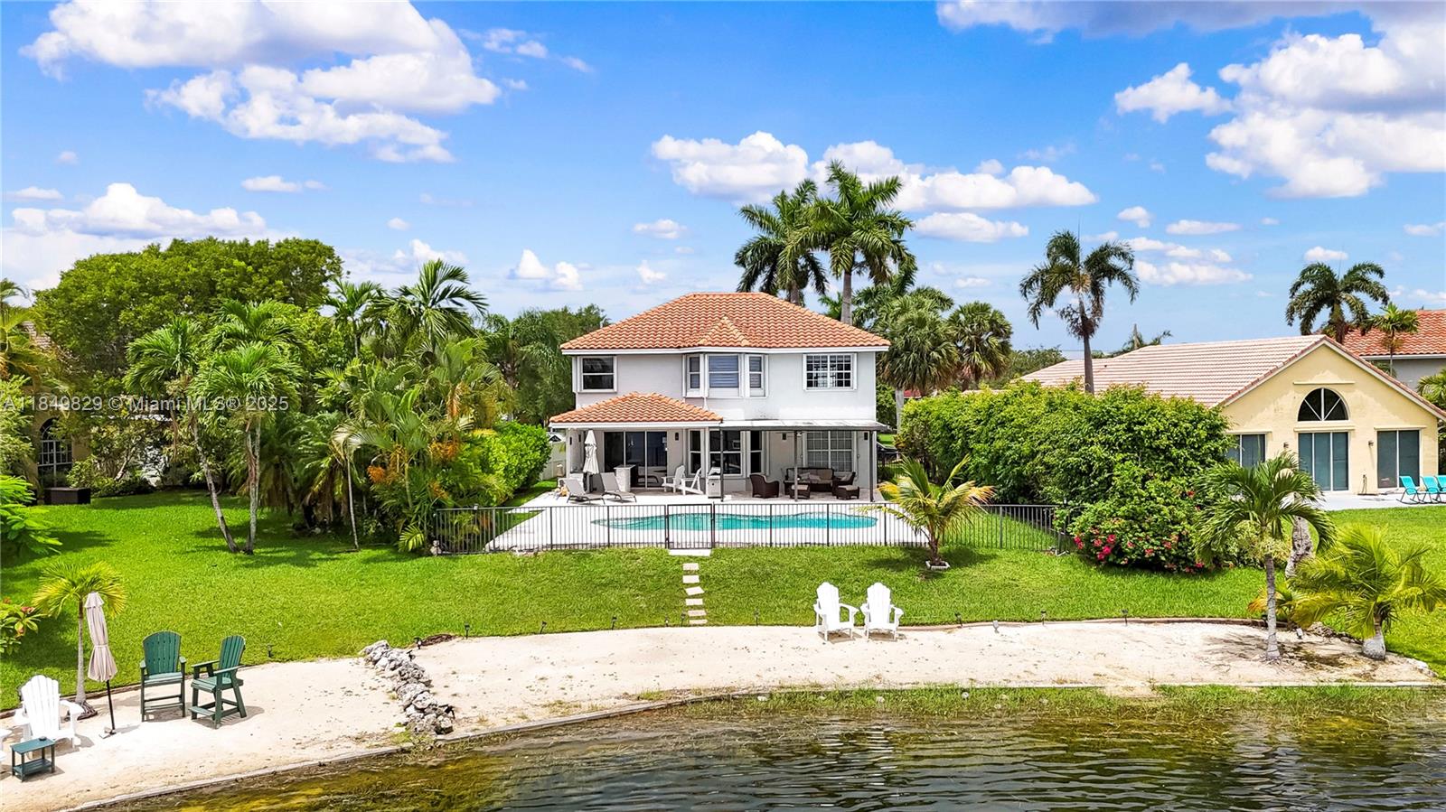Breathtaking lake views and resort-style living await in this stunning 4-bedroom, 2.5-bath two-story home in highly sought-after West Pembroke Pines. Located on one of the most desirable lots on the lake, this property offers panoramic water views, a spacious patio with elegant pavers, a private beach, and a pool overlooking the lake—perfect for relaxing or entertaining. Enjoy the outdoor kitchen/bar with quartz countertops under a covered area, plus a pergola for shaded seating. The home features a new roof and A/C. The primary suite has lake views, a walk-in shower, soaking tub, new vanity, and custom walk-in closet. A rare opportunity to own a lakefront home with premium views, upgrades, and outdoor living.