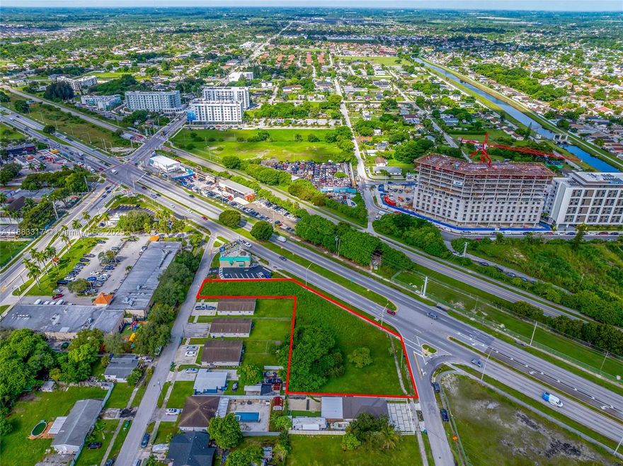 Fausto Commercial proudly presents an outstanding opportunity to acquire a 34,345 SF commercial development site with direct frontage on US-1 & SW 214th Street in the Goulds neighborhood. The property offers excellent visibility along one of Miami-Dade’s busiest corridors, with strong traffic counts and convenient access to surrounding neighborhoods. Empowered by Florida’s Live Local Act, the development may exceed typical density limits, and height limits. The site is currently vacant and located within Miami-Dade County’s Rapid Transit Zone. Under the Live Local Act, developments are permitted to match the tallest approved height within a one-mile radius. A nearby parcel, allows buildings up to 25 stories, providing the legal precedent for the potential height.