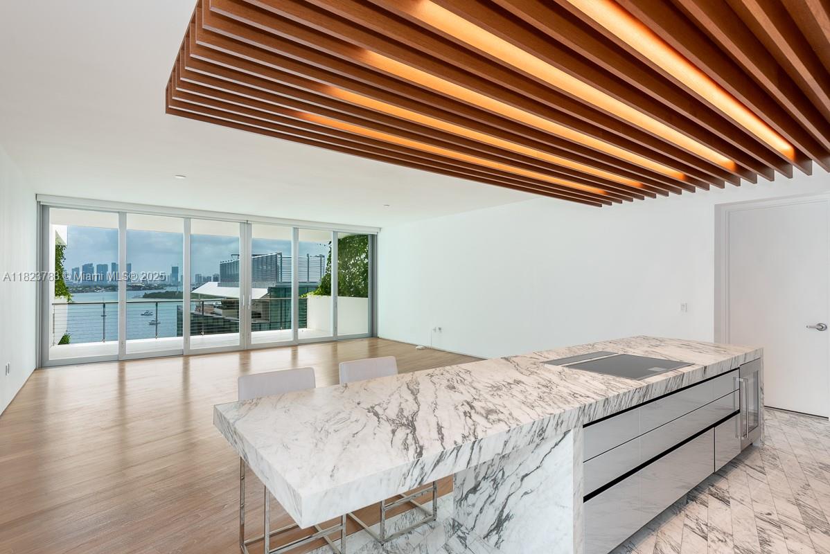 Welcome to the timeless elegance of Monad Terrace, an architectural masterpiece by Pritzker Prize-winning Jean Nouvel. This 2,500 SF residence features 3 bedrooms, 3/1 bathrooms, plus a versatile den, blending modern sophistication with the natural beauty of Biscayne Bay. Enjoy breathtaking bay, skyline, and ocean views from multiple oversized terraces—perfectly positioned for both sunrise and sunset. Inside, refined finishes include a Calcutta marble kitchen, Gaggenau appliances, custom cabinetry, newly designed closets and private elevator entry. Monad Terrace is a boutique collection of just 59 residences, offering a curated lifestyle with amenities such as a bay-front infinity-edge pool, sun deck, wellness-focused juice bar, strength and cardio gyms, valet service, and 24/7 concierge.