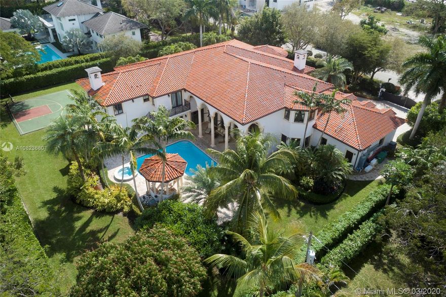 Significant Pinecrest gated estate that is much more than just a home - it’s a lifestyle. Beautifully appointed and meticulously maintained, this expansive home was completely redone in 2013. Impressive entry with walls of glass, soaring ceilings, and grand staircase. Family and friends will gather in the large open social areas and enjoy the game room with built-in bar, state of the art movie theater, gym, and wine cellar. French doors in the family room open to backyard bliss where entertaining is effortless. Outdoor living at its finest with a heated pool/spa, manicured landscaping, half basketball court, and summer kitchen. When you’re ready for solitude, bask in a 1,750 sq ft master suite with gas fireplace in the master bath. Generator. Definitely worth a visit. Come and be dazzled!