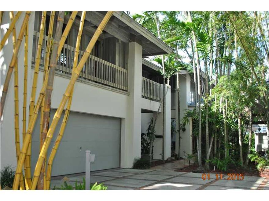 Spectacular Polynesian Paradise Resort in Exclusive Private Coconut Grove Gated Community. Romantic "Casablanca" Master Suite, Plus 4 Bedrooms & Library/Den, 20 Ft. Volume Ceiling in Entry, Amazing Natural Sunlight Thru-Out, Black Limestone Floors and Dra matic Staircase.  Renovated Kitchen with Onyx Tiles, Huge Outside Entertainment Pavilion with separate BBQ area Overlooking Pool and Canal. Bay/Ocean access with No Bridges.  Impact Windows