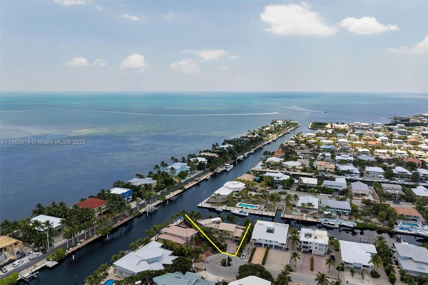 A Waterfront Masterpiece — 166 feet of pristine canal frontage, resort-style pool, and a massive owner's suite define this one-of-a-kind residence. Beautiful and spacious 3-story waterfront residence offering an impressive 166 feet of canal frontage with direct access the ocean. Designed for comfort and entertaining, this home blends elegant interiors with resort-style outdoor living. Inside, the main living area boasts soaring ceilings, natural light, and balconies that frame tranquil water views from every room. The open kitchen features custom wood cabinetry, stainless steel appliances, granite countertops, and an expansive breakfast bar that flows into the great room and dining space. Elegant stone flooring and quality finishes throughout. Seller Financing Possible to right buyer.