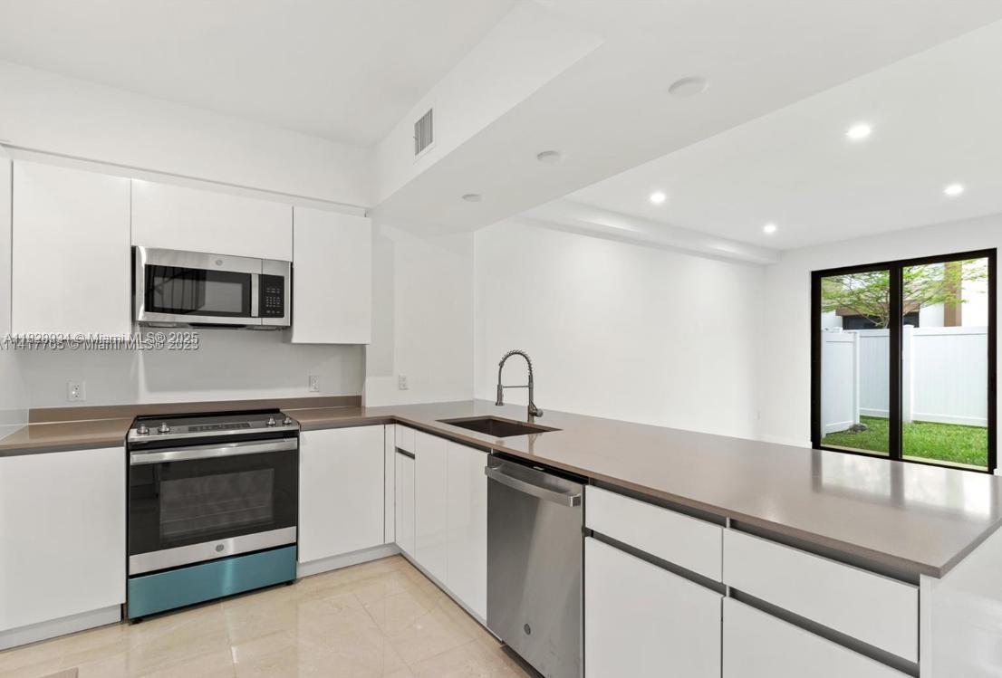 LOOK NO MORE* JUST LISTED* Newly built 3-bedroom, 2.5-bathroom townhouse in a secluded, gated community in the heart of Broward. This spacious 2-story home features high ceilings, porcelain floors, new impact windows/doors, custom blinds, designer fixtures & lighting, a private fenced patio—ideal for relaxing or entertaining. The kitchen is outfitted with stainless steel appliances, European Cabinetry, Quartz counter tops, new AC system, tankless water heater, and in-unit washer/dryer for ultimate convenience. Pet-friendly comm. 2 car carpot and EV charger. Perfect for both investors and first-time homebuyers. Close to the iconic Hard Rock Hotel/Casino and minutes from major highways, Dania Pointe shopping, and dining.