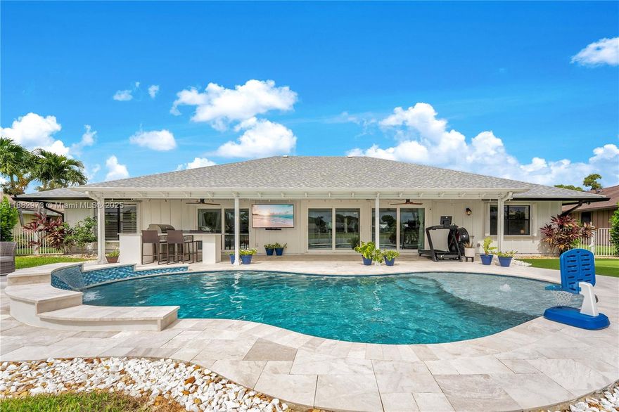 Golf membership is OPTIONAL! Turn-key 3/2 lakefront home+den (easily convertible to 4th bedroom) with oversized garage on quiet cul-de-sac. Open layout with lanai, NEW saltwater pool, lake & golf views. Enjoy skylights, the sunset, sunrise & lots of natural light throughout. Upgraded kitchen & master bath, new flooring, and fireplace with shiplap wall. Updates: roof (2021), Trane AC (2021), ducts/insulation (2022), water heater (2022), impact sliders (2019), full interior/exterior paint (2024), putting green & outdoor kitchen w/ fridge, plus freshly painted driveway (2025). Enjoy a community pool, spa/hot tub, tennis, pickleball, driving range, 18-hole golf course, & restaurant.5 miles to Jupiter Island beaches. Most recent comparable sale closed 09/30 at $322.30 per sq. ft. (2,417 sqft).