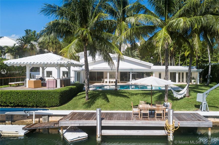 Stunning, magazine quality waterfront home on the exclusive & idyllic island of Key Biscayne. Enjoy water views from light-filled living spaces w/ soaring, vaulted wood-beamed ceilings, a striking white color palette & a modern vibe throughout. Updates include new: limestone flooring, spa-like baths, impact glass, interior & exterior Sonos sound system, new dock w/adjoining floating dock & new stone terrace & pool deck. European-style kitchen features black granite countertops, Viking appliances & breakfast area. Lush, tropical garden surrounds the resort-like outdoor space that offers an expansive covered terrace, pool & gazebo w/ spectacular sunset views. Protected, private dock w/davits & no bridges to the bay. Direct ocean access, 180’ turning basin at the head of the canal.