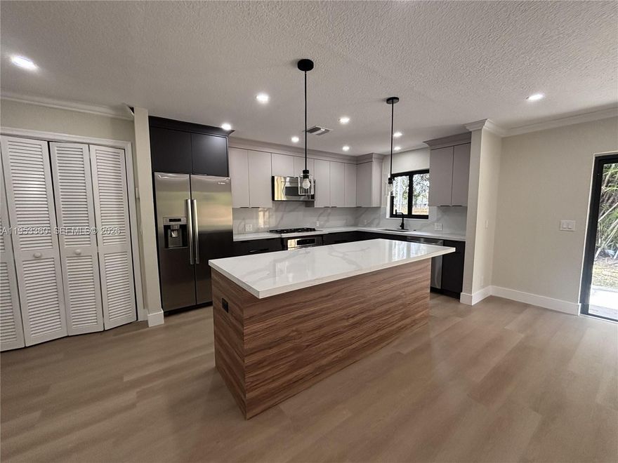 Beautifully 3-Bedroom, 2-Bath Home with 2-Car Garage in Lake Mango Shores! Welcome to this move-in-ready single-family home ideally located off Florida Mango Rd in the desirable Lake Mango Shores community. This property features a new permitted roof (2025), fresh interior paint, and stylish modern vinyl flooring throughout. The updated kitchen with contemporary appliances offers both functionality and appeal for today’s lifestyle. Enjoy a private fenced-in yard, perfect for entertaining. An excellent opportunity for buyers seeking comfort, tranquility, and modern living in a well-established neighborhood. All ages are welcome, Low HOA.