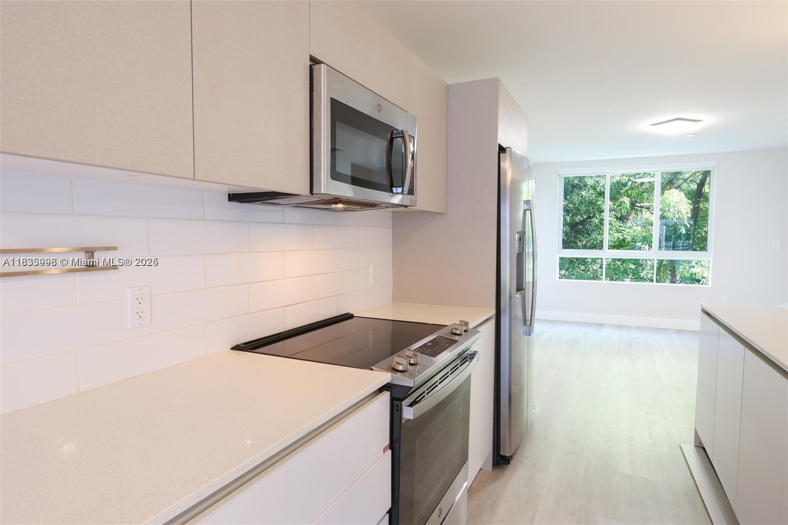 Aventura Village, completed in 2020, features spacious split-level, contemporary townhomes centrally located near Aventura, on W. Dixie Highway. This beautiful unit features an open kitchen floor plan with center island, stainless steel appliances, soft-close cabinets and split living and dining areas for extra comfort. Bedrooms are located on the second level, along with a comfortable den/home-office space, and convenient full-size washer and dryer units upstairs. This residential complex is fenced with gated entry for extra security, while the community pool adds just the right touch for weekends at home. This lovely unit is unfurnished, move-in ready and easy to show. Added benefit, the unit has been freshly painted.
