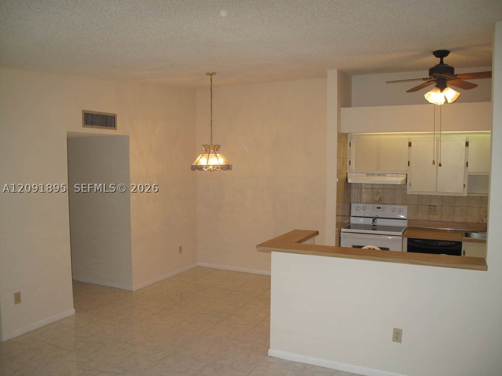 Photo of 9940 S Belfort Cir #203, Tamarac, FL 33321 (MLS # A12091895)
