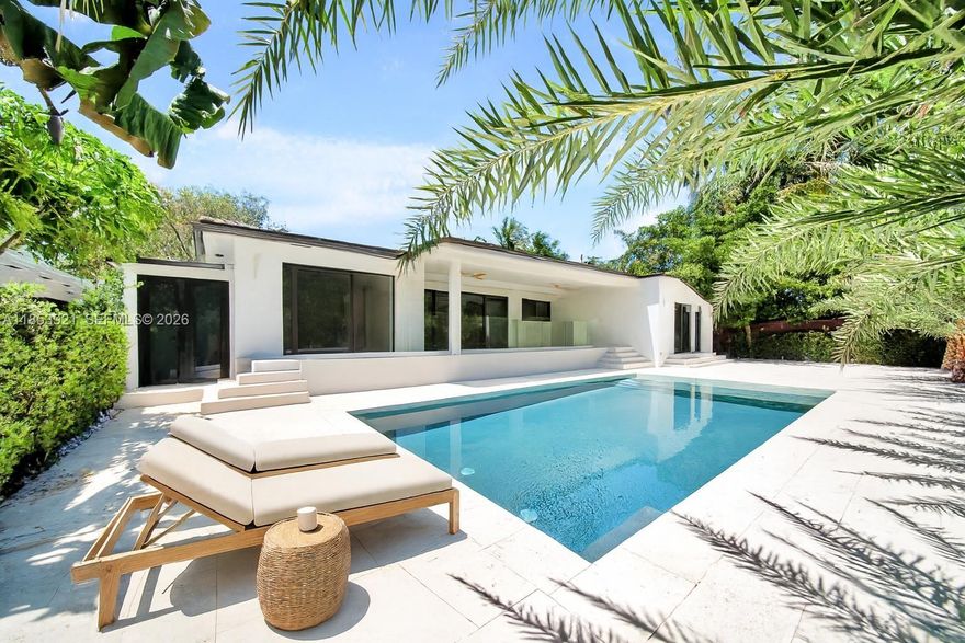 PRICE REDUCED. Stunningly renovated 4-bedroom, 3.5-bathroom Pool House nestled in Bayside Historic District. It blends timeless architecture with sleek, modern finishes, all just minutes from Miami’s most vibrant neighborhoods.
Open-concept living spaces, soaring ceilings, and seamless indoor-outdoor flow. The chef’s kitchen is outfitted with custom dark wood cabinetry, luxury stone countertops, and brand new appliances, including a gas stove. Floor-to-ceiling sliding doors lead to a tropical private oasis featuring a brand-new pool, lush landscaping, and elegant palm-lined privacy. Every bathroom has natural stone. The primary suite features a walk-in closet with custom-lit built-ins, providing both storage and style. Outdoor storage. Elevated House with new roof and impact windows.