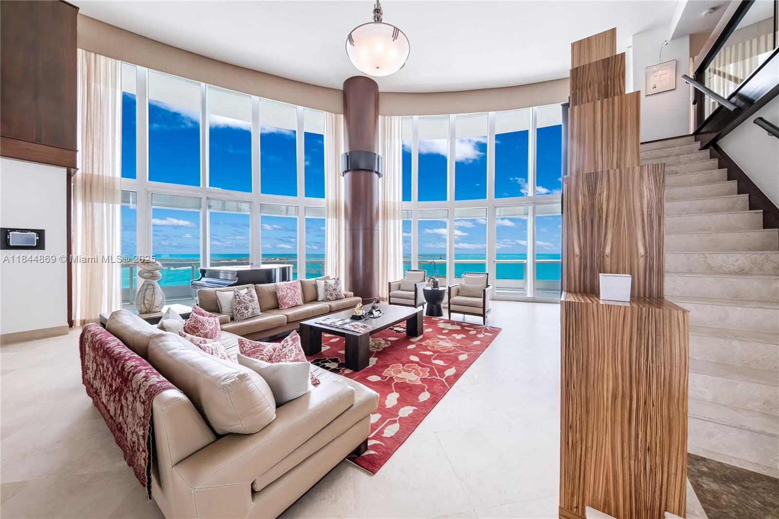 Discover this stunning 2-story corner residence at the iconic Santa Maria in Brickell. This sky-high home features an expansive wraparound terrace with sweeping ocean and bay views. Enter through a private foyer to walls of glass framing dazzling water vistas, and entertain with ease across multiple living and gathering spaces. The gourmet kitchen, with Gaggenau and Sub-Zero appliances, flows seamlessly into the dining area. The lavish primary suite offers a walk-in closet and spa-like bath with stone finishes, rainfall shower, and jacuzzi tub. Additional highlights include a soundproof movie theater, versatile den, high-end finishes, 3 parking spaces, storage, and more. Residents also enjoy newly reimagined amenities including a state-of-the-art fitness center, pool, tennis court, & more.