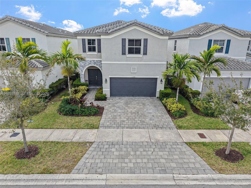 Take advantage of the ONCE IN A LIFETIME assumable 2.7% INTEREST RATE! Welcome to this beautifully upgraded 4 Bedroom, 3.5 Bathroom lakefront home located in the desirable Riviera community of Homestead. This spacious residence features large living spaces and bedrooms, upgraded tile flooring, and a well-designed layout ideal for modern living. In addition to the primary suite, the home offers a secondary master bedroom / junior suite with its own private bathroom and walk-in closet, perfect for guests or multi-generational living. Enjoy tranquil lake views from the backyard, complete with upgraded pavers in the backyard ideal for relaxing or entertaining. Additional upgrades include a whole-home water purification system and whole home solar panel system, offering both comfort and energy efficiency. The Riviera is a well-maintained community offering resort-style amenities, including a clubhouse, beach entry style pool and spa, pool side cabanas, fitness center, and recreational areas for walking and parks, in a safe and secure gated community all conveniently located near shopping, dining, schools, health care and major highways. This move-in-ready lakefront home combines space, upgrades, and lifestyle — a must see.