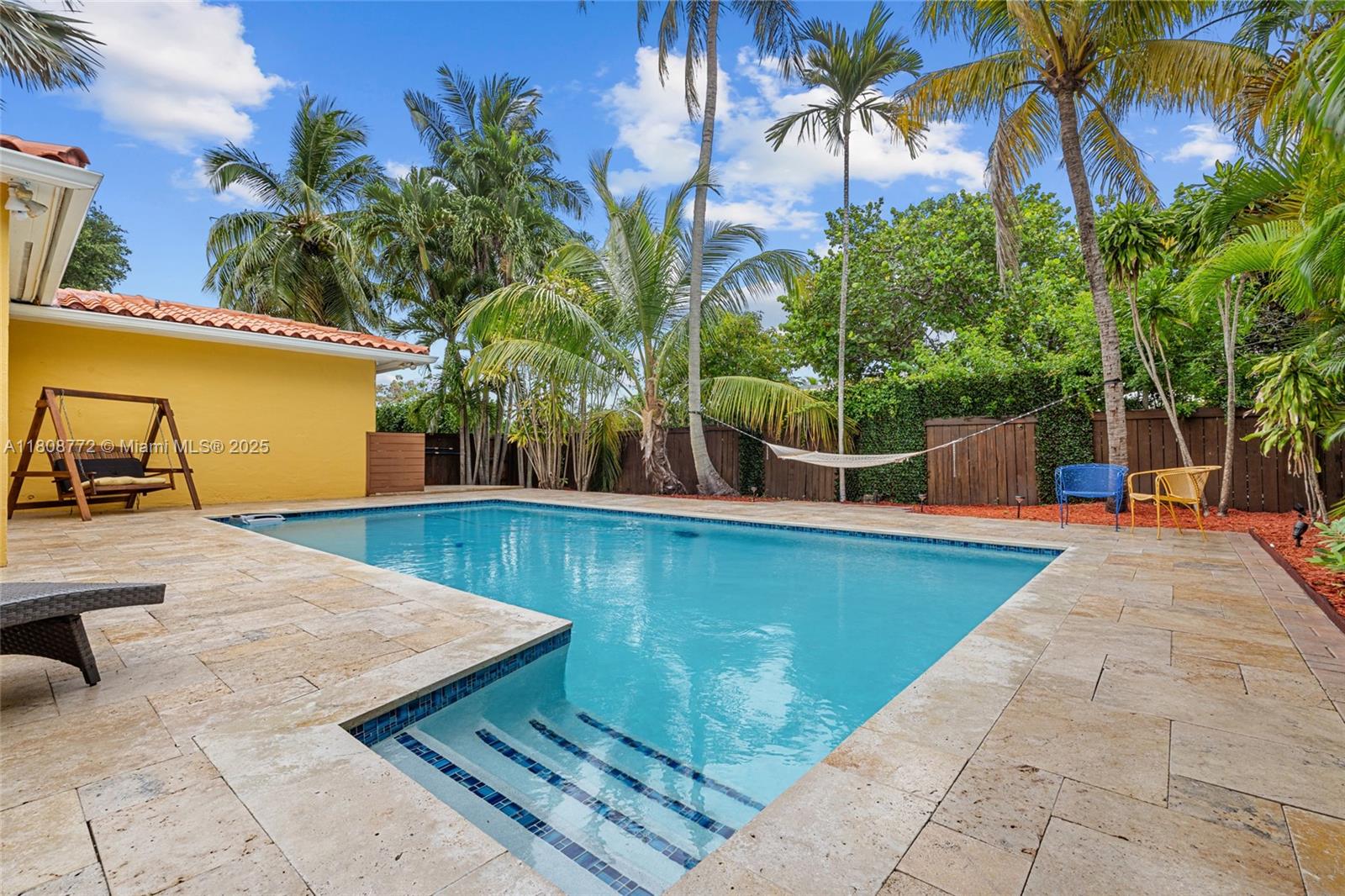 Double lot – 12,400 Sq Ft in a prime South Miami location. This updated 3-bedroom, 3-bath home offers a spacious layout with impact windows, porcelain and wood floors, and a modern kitchen with updated bathrooms. The home includes a cabana bath with direct access to the pool area, ideal for outdoor living. Enjoy a large covered terrace, oversized pool, and travertine deck, perfect for entertaining. The lot is divided into two distinct areas: one with the pool and entertainment space, the other with a peaceful, landscaped yard, garden lighting, and a storage shed. A gated carport and circular driveway with tall Clusia hedges provide privacy and a clean entrance. Located minutes from Coral Gables, University of Miami, dining, and shopping. No flood zone. Check out Property Virtual Tour link