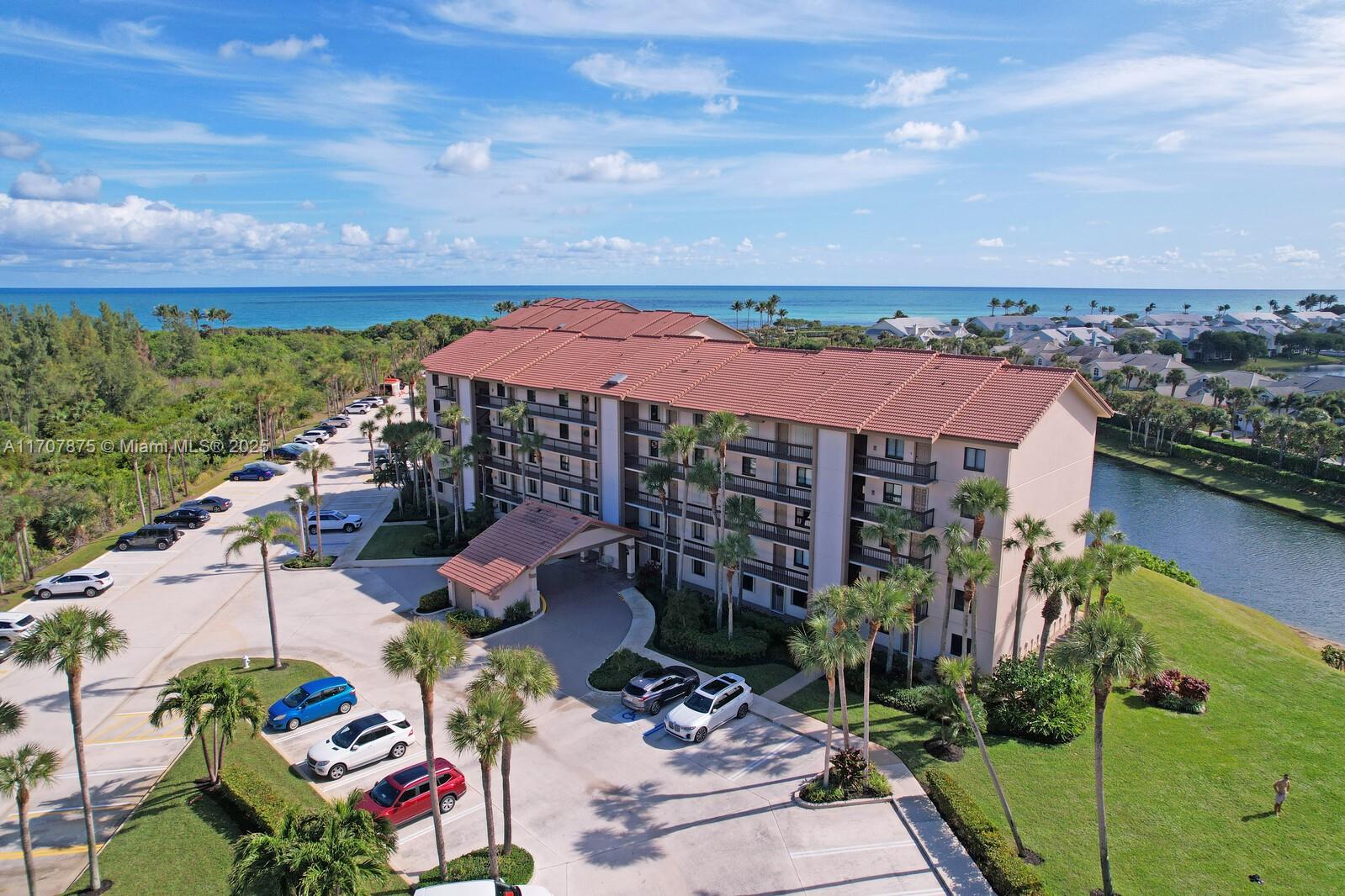 Welcome home to paradise, rarely available penthouse ocean view home with 20 foot-tall vaulted ceilings in the living room, dining room, kitchen and bedrooms. Enjoy peaceful ocean and lake views from inside or from your oversized balcony with wood-like tile, hurricane impact slider and an electric retractable awning. The gourmet kitchen features high-end custom soft-close wood cabinetry, granite, under-mount lighting, crown molding, imported Italian decorative tile, stained glass window and top of the line stainless steel appliances. The primary bedroom offers
an en-suite and a walk-in closet with built-in shelves. This home has a total open floor-plan and is great for entertaining. There is a private gated walkway to the beautiful Jupiter Beach which is just across the street.