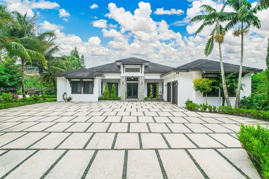 This impressive 10-acre Redland estate was meticulously constructed in 2017. It includes a 1,400 sq ft guest house. The primary residence spans over 5,583 sq ft with impact doors & windows. It features 4 bedrooms, 4.5 bathrooms, an office and a 2 car garage. Formal dining and living room has a built-in bar area, offering an elegant space. Each bedroom includes a private bathroom and walk-in closet. The chef's kitchen with solid wood cabinets and exquisite white quartz countertops. The expansive family room leads to an outdoor built-in BBQ and patio area. Travertine patio floors, pool, and fireplace area, ideal for hosting guests. This estate offers the privilege of residing in your own private paradise with a variety of tropical plants that allow you to experience nature at its best.