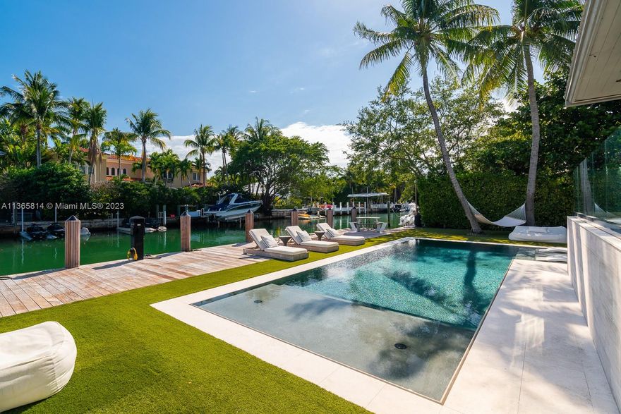 Spectacular completely remodeled waterfront home in sought after Key Biscayne. Beautiful one story with open floor plan, stunning water views and abundant natural light.  Enjoy the Tropical Key Biscayne lifestyle with a modern architectural design.  Ideal floorplan with primary bedroom and 3 kids bedrooms on one side, plus a guest room, and staff quarters and a separate 1/1 Gym/ Guesthouse. Exquisite custom finishes featuring Limestone and Marble floors, Italian Kitchen and doors and top of the line materials throughout. Covered terrace with summer kitchen overlooking the pool and patio area. Private dock with direct ocean access.