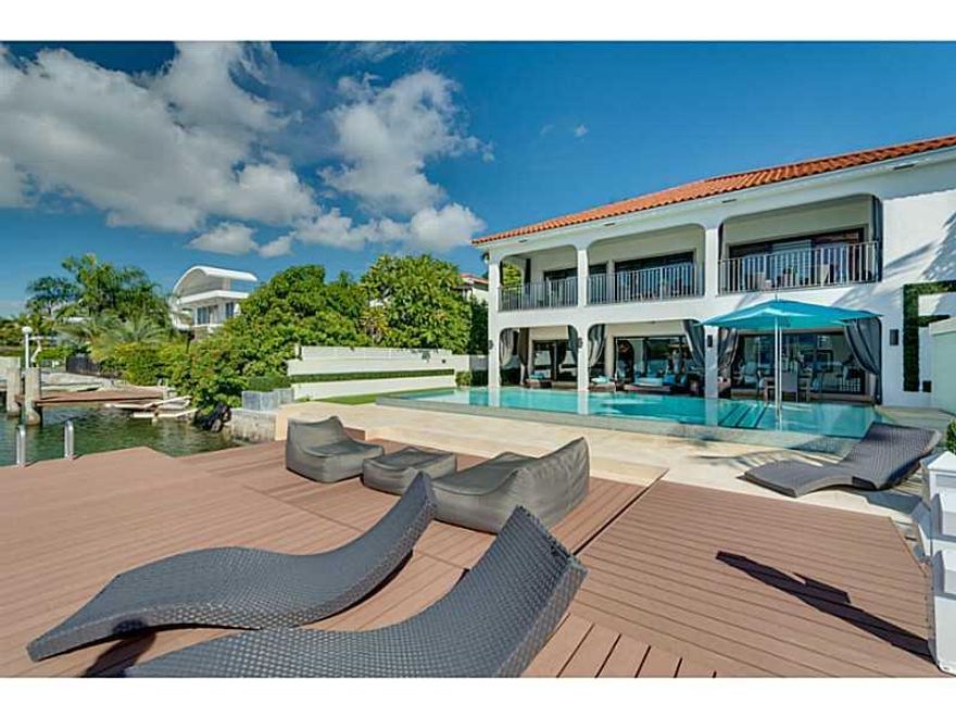 Spectacular Miami Skyline & open water views can be seen from this elegant Palm Island, 2-story residence w/heated Infinity pool, new large dock & 2-car garage. Interior features: LED lighting, elevator, custom shades, gourmet kitchen, wine cellar, wet bar, home theater, sound system & alarm system w/4 cameras. Formal dining rm, living rm, & family rm w/ceiling artwork. All large bedrooms w/en-suite baths & walk-in closets. Master w/Jacuzzi & terrace overlooking Downtown Skyline.
