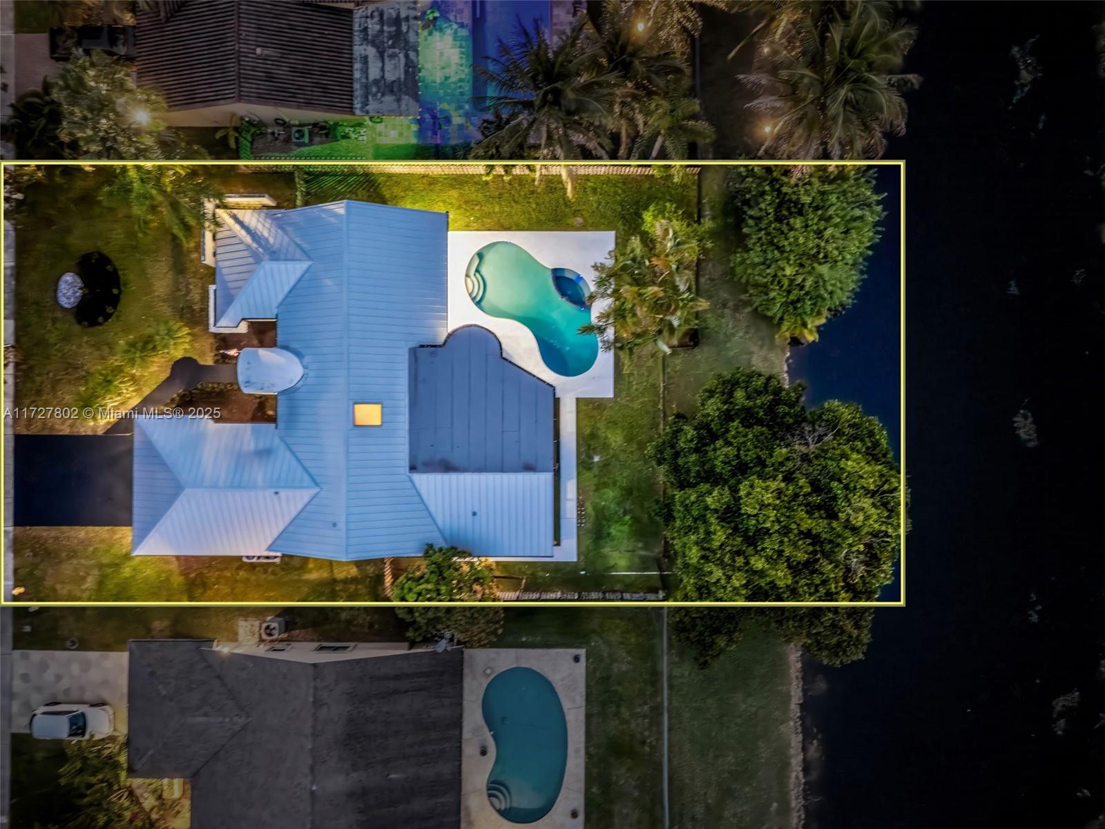 2022 metal roof, 2024 impact windows and doors and 2021 A/C unit, 5/3/1 Home with Pool, Spa & Canal Access. One-of-a-kind 5-bedroom, 3.5-bath home in Jacaranda, featuring 15-ft vaulted ceilings and being 1 of only 2 homes of its design in the neighborhood. Enjoy your backyard, overlooking a scenic canal, perfect for small boats. The split floor plan includes a versatile bonus den that can easily be converted back to its original layout. This home is filled with natural light throughout, enhanced by a skylight, brand-new fixtures, and landscape. The open-concept kitchen, along with fresh interior and exterior paint, makes this home move-in ready.