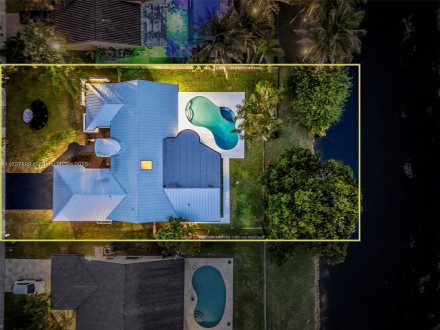 2022 metal roof, 2024 impact windows and doors and 2021 A/C unit,  5/3/1 Home with Pool, Spa & Canal Access. One-of-a-kind 5-bedroom, 3.5-bath home in Jacaranda, featuring 15-ft vaulted ceilings and being 1 of only 2 homes of its design in the neighborhood. Enjoy your backyard, overlooking a scenic canal, perfect for small boats. The split floor plan includes a versatile bonus den that can easily be converted back to its original layout. This home is filled with natural light throughout, enhanced by a skylight, brand-new fixtures, and landscape. The open-concept kitchen, along with fresh interior and exterior paint, makes this home move-in ready.