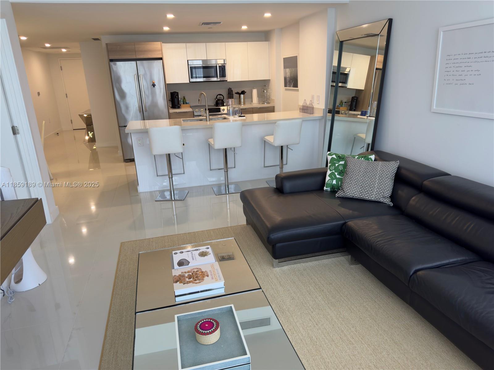 Enjoy the best of Bay Harbor Islands with this desirable and spacious unit, unit offers two assigned covered parking spaces and access to all the upscale amenities of a luxury building. Whether you're relaxing by the pool, working out in the modern fitness center, or entertaining guests, this residence offers comfort, convenience, and elegance. The unit offers a large balcony overlooking the city. Unit comes fully furnished. Roof amenities with infinity edge pool, Barbecue Grill and More..come and enjoy the best sunsets of the island. Other amenities 24 hours front desk, spacious Gym, boat docks, media room and more..