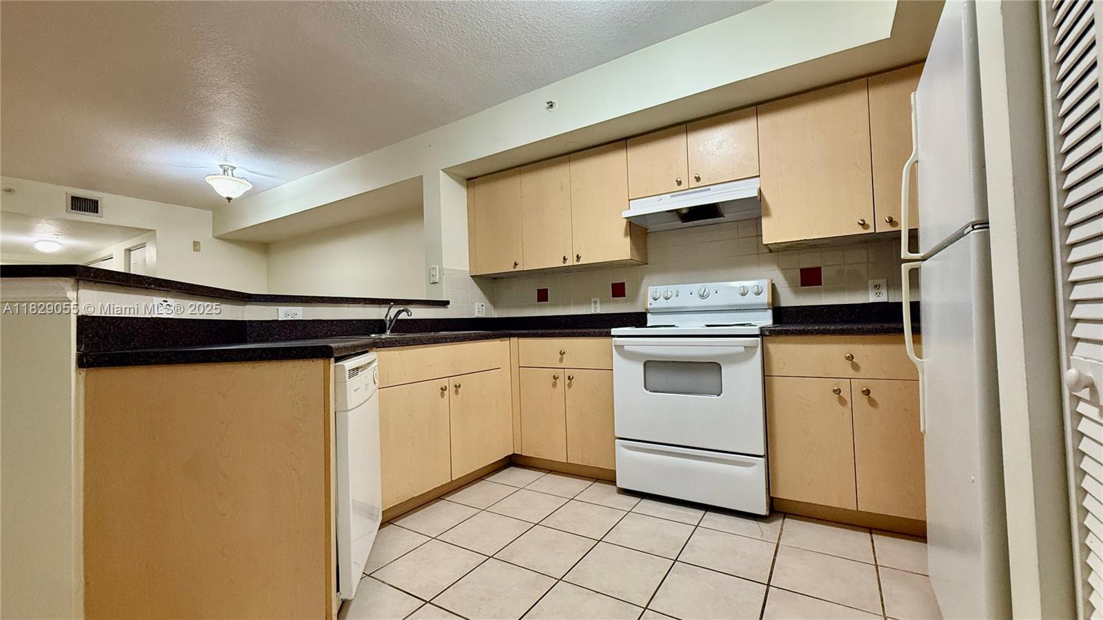 Ground-floor 3-bed / 2-bath condo in gated Emerald Isle at Laguna Lakes. This bright 1,300 sq ft split-floorplan unit features a granite kitchen with breakfast bar, full-size washer & dryer, and screened patio. The primary suite includes a walk-in closet and a dual-sink bathroom. Photos reflect current condition — necessary cleaning and repairs are in progress. Enjoy resort-style amenities: lakeside pool & spa, gym, racquetball, tennis, clubhouse, business center, playground, and 24/7 security. HOA includes water, sewer, cable, and internet. Investor-friendly. Convenient location near I-95, Palm Beach Outlets, and downtown. Showing via ShowingTime – lockbox code provided upon confirmation.