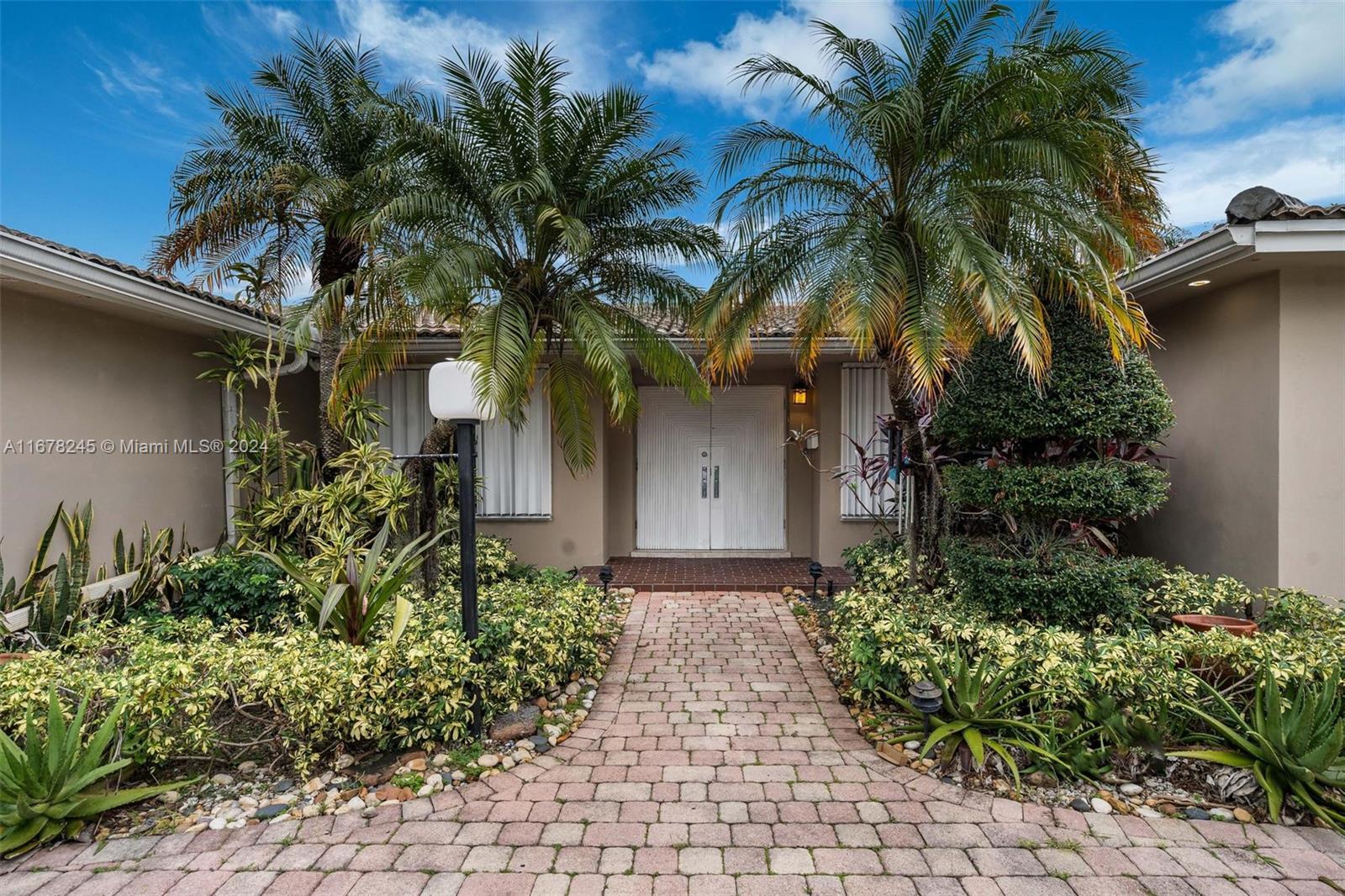 Step into this beautiful single-family home, boasting a designer European kitchen with custom cedar wood cabinetry, a unique granite countertop, and a central island perfect for entertaining. High-end appliances and elegant French doors enhance the modern living experience. The home features sleek porcelain floors throughout, a bright and inviting Florida room, and a screened patio that leads to a spacious backyard with a charming barbecue area—ideal for outdoor gatherings. A circular paved driveway adds curb appeal and convenience. Located near top-rated schools and places of worship, with easy access to I-95, this home offers both comfort and convenience. A must-see gem!