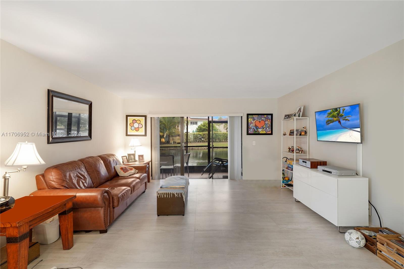 Discover modern comfort in this fully remodeled 2-bedroom, 2-bath corner condo with stunning lake views. Porcelain floors flow throughout, complementing a stylish kitchen with quartz countertops. Impact windows, doors, and a newer A/C unit (5 years old) ensure peace of mind and energy efficiency. Enjoy serene water views from the living area and patio, or relax on the tiled, screened patios at the front and back. A storage room adds convenience, reserved parking space is right outside with ample guest parking nearby. Enjoy access to the Town Center Club at Bonaventure, offering amenities like a gym, tennis, pools, bowling, roller skating, indoor basketball, and much more for the entire family. This home combines modern upgrades with a vibrant community lifestyle—don’t miss it!