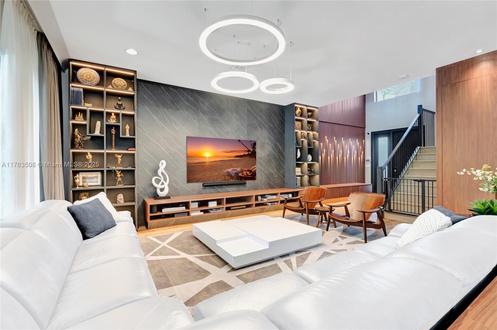 A true modern masterpiece in Lotus, Boca Raton—over $550K in upgrades. Features a custom black Murano crystal chandelier, Samsung 85” 8K Neo QLED TV, Sonos Arc soundbar, imported custom cabinetry, and Lutron smart lighting. The chef’s kitchen stuns with a Samsung fridge (internal camera) and a bold LED-lit 3D bar. Spa-style primary suite with rainfall showers, body jets, and digital bidet. Enjoy a soundproof home theater with Epson projector and Bowers & Wilkins system. Outdoor living shines with a J-500 Jacuzzi, Sonos+Sonance audio, summer kitchen, retractable pergola, and fireplace. Designed for luxury, tech, and lifestyle.