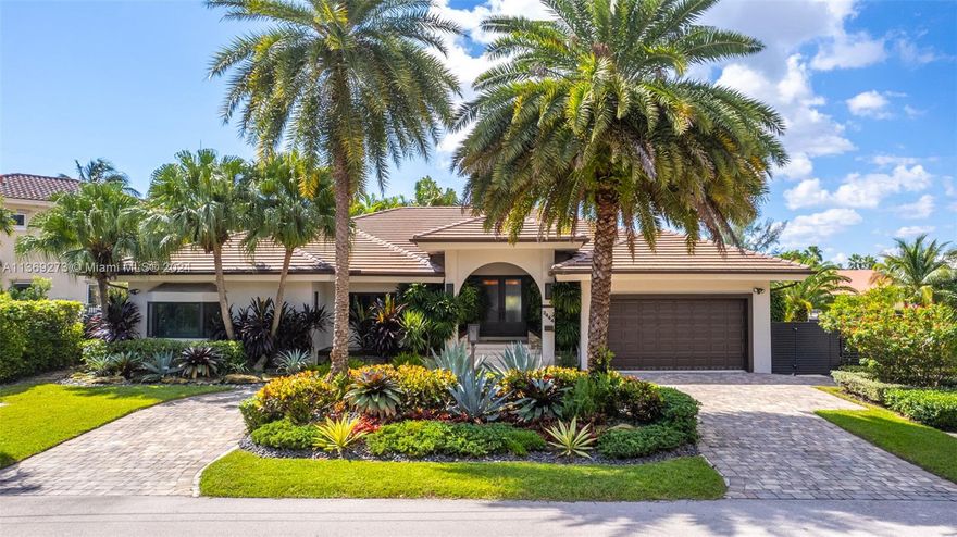 This stunning one-story custom-built home is a dream come true for yacht owners, offering 50ft of waterfront property. The home boasts high ceilings. Perfect for boat enthusiasts. Professionally decorated with the finest quality finishes throughout, including custom-built wall units, impact windows and doors, wood plank floors, and a newer (1 year) flat tile roof. The home features a built-in bar, a huge great room, and a newer remodeled spacious eat-in kitchen with marble countertops and backsplash, a Miele gas stove, Miele oven, microwave, espresso, and wine cooler, built-in Subzero refrigerator and freezer, tall cabinets, and pull-out pantries. A must see opportunity.