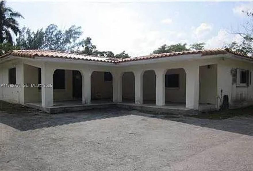 Spacious and versatile! This unique property features 3 bedrooms, a dedicated office, 3.5 bathrooms, a formal living room, dining area, and a kitchen equipped with granite countertops, wooden cabinets, and stainless steel appliances. One of the bedrooms is configured as a private suite with its own bathroom, living room, and side entrance—ideal for guests or rental income. A separate rear structure offers 2 additional bedrooms and 1 bath, perfect for extended family or rental opportunities. The property sits on a builder’s ¾ acre, fully fenced with remote gate entry, lush with fruit trees, and canal access in the rear for jet ski and or flat boat. A rare find with space, privacy, and potential!