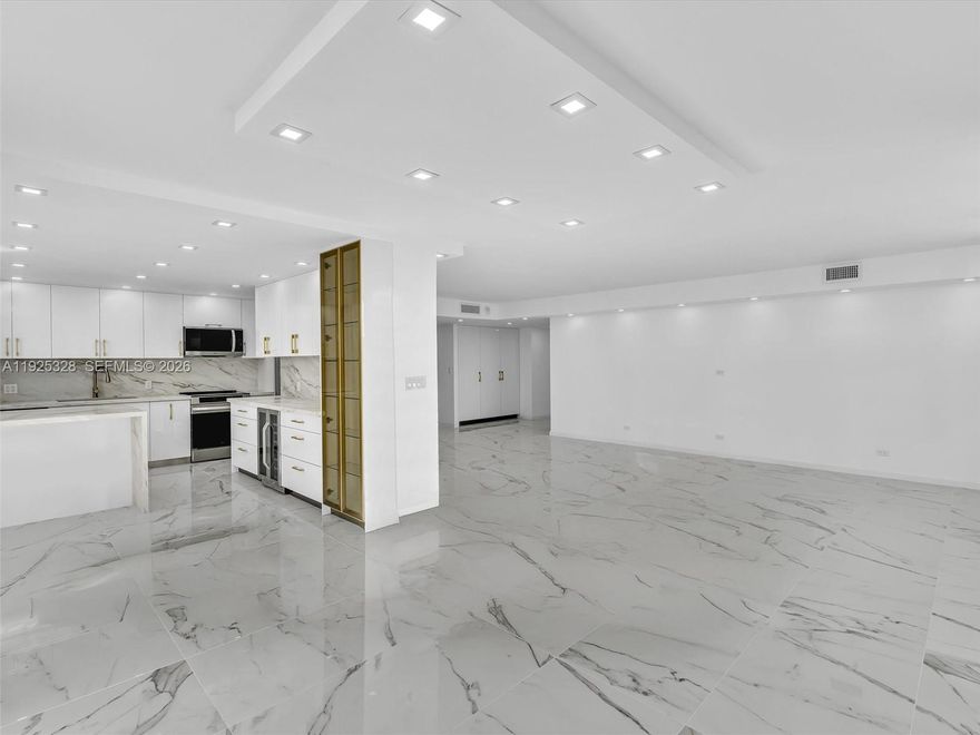 Step into luxury living in this fully remodeled corner 2-bedroom, 2-bath residence featuring the largest 2-bedroom floor plan in the entire Winston Towers community. This ultra-modern home has been professionally redesigned to deliver a seamless blend of sophisticated style, everyday functionality, and smart-living upgrades.

The interior showcases a brand-new modern kitchen with stainless steel smart appliances, custom details, and generous counter space ideal for both cooking and entertaining. Custom-built, fully air-conditioned closets and pantries provide exceptional comfort while preserving stored items. Premium stone flows throughout the countertops and floors, accented with refined gold inlay and designer hardware that add elegance and cohesion. Hurricane-impact windows enhance safety, energy efficiency, and peace of mind, while every room reflects thoughtful design that balances beauty and practicality.
The building offers unmatched reassurance as the only Winston Towers property to have completed both the 40-year and 50-year recertifications. Ideally located near top-rated Florida schools and just a minute’s walk from the beach, as well as restaurants, cafes, and shopping.

Residents enjoy resort-style living with a fully renovated pool and community amenities. This move-in-ready residence has been completely reimagined, offering a rare opportunity to be the first to enjoy a meticulously designed home with modern comfort and lasting value.