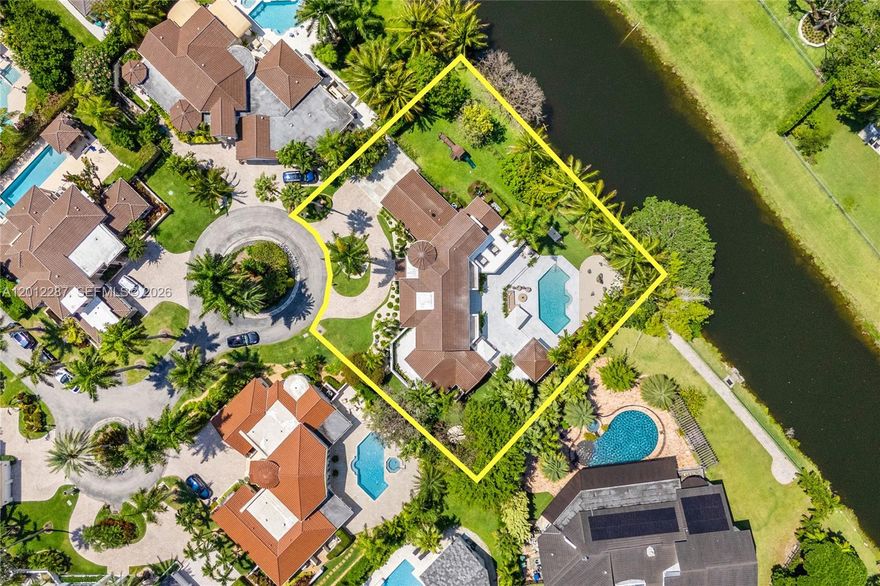 Tucked behind the gates of an exclusive enclave of just 12 residences, this two-story Mediterranean villa offers the rare combination of privacy, serenity, and an unbeatable North Pinecrest location. Only 3 homes have come to market here in the last decade; opportunities like this simply don't come around.
Set along a tranquil canal and surrounded by lush, mature landscaping, the home welcomes you with dramatic 20-foot ceilings and an abundance of natural light. The thoughtfully designed floor plan features 7 bedrooms and 6 bathrooms, including a spacious primary suite, large dedicated office, and separate service quarters on the main level. Three additional bedrooms are upstairs, and a fully separate 1-bedroom/1-bathroom poolhouse sits off the backyard, ideal for guests or extended stays.
The expansive backyard is built for entertaining, fully renovated anchored by a summer kitchen. Minutes from Gulliver, Beth Am, and St. Thomas, plus Miami's finest dining and shopping.