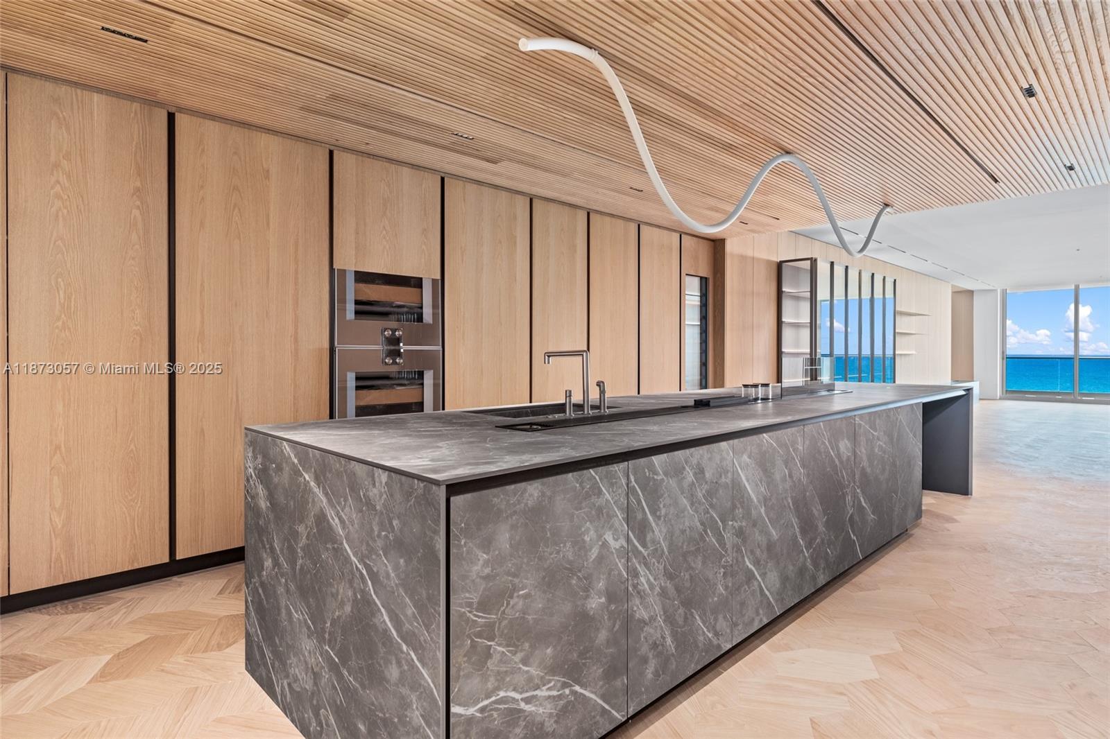 An exceptional offering at Fendi Château Residences. Designed by award-winning Yodezeen, this 4-bedroom, 3.5-bath with staff quarters and family room sets a new standard for oceanfront living. Positioned on the 7th floor with east-to-west flow-through layout, it features 10-ft ceilings, floor-to-ceiling glass, & expansive terraces framing views of the Atlantic, Downtown Miami, & Surfside sunsets. Wood floors by Foglio D’Oro, sleek Lualdi doors, & Italian marble extend throughout. The Poliform kitchen includes custom cabinetry, hidden cooktop, and Gaggenau appliances. Baxter and Artemide lighting add sculptural drama, while the primary suite offers leather panels and spa-like Antonio Lupi vanities. Residents enjoy world-class amenities and valet-only service. Select images virtually staged.