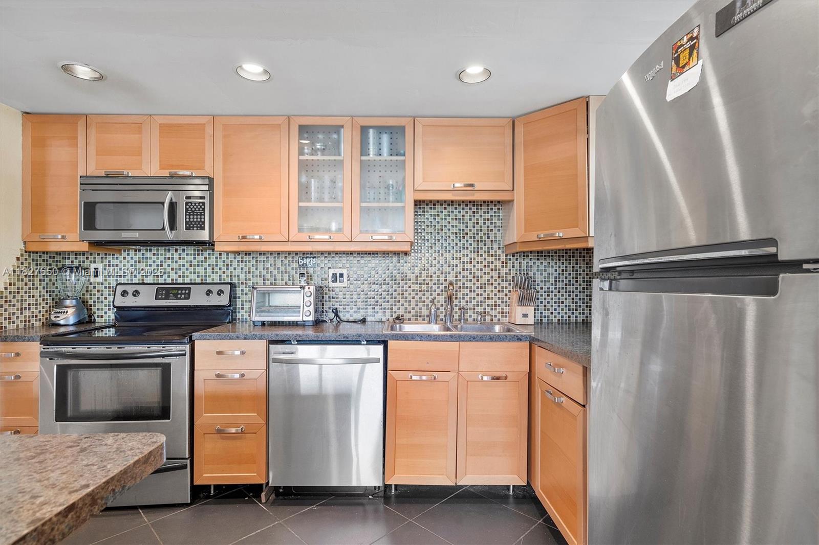FIRST FLOOR 2 BED/2 BATH CORNER UNIT located in desirable Watergate Condominium and Yacht Club. Unit has ROLLADEN HURRICANE SHUTTERS. Plenty of closets. Waterfront Complex offers Boat Docks with ocean access for $25/month including trailer parking! Wonderful amenities including 2 heated pools, waterside Party Room, Sauna, Exercise Room, Tennis Court, Clubhouse with 2 pool tables, Library/Office, BBQ area and more! Unit comes with Parking Space that could not be any closer to the unit and there are lots of Guest Parking available. Basic TV cable included in the HOA. Unit comes with extra storage unit. Common laundry facility is conveniently located nearby and on each floor. All ages welcome. Great location! Close to airport, major highways, and Hollywood Beach Boardwalk!