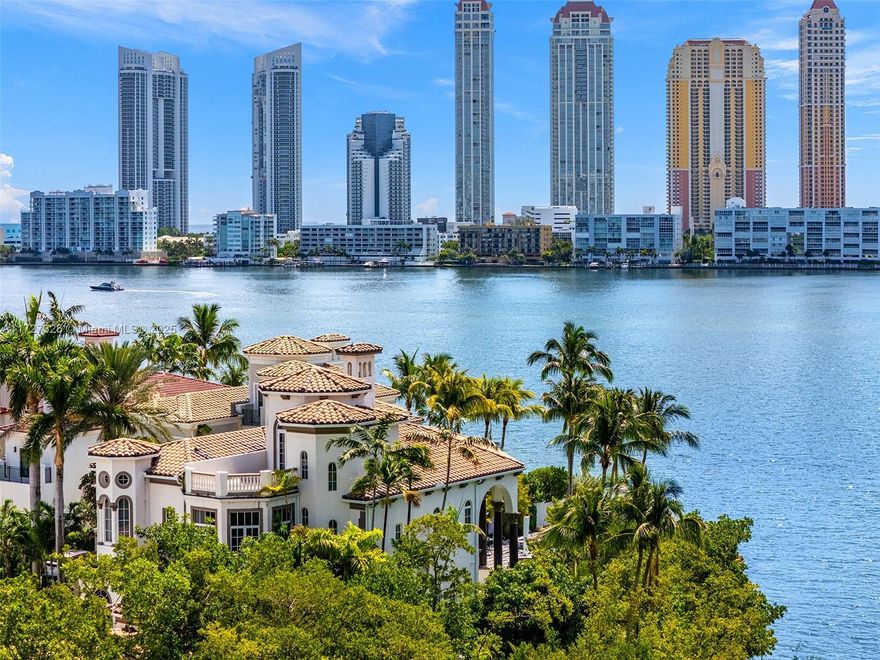 Experience unrivaled luxury on the open bay in the gated community of Island Estates. This rare home sits on one of only two double lots (24,772 sqft) with 240 ft of water frontage, offering the best views. Features include vaulted 30 ft ceilings, top finishes, a gourmet kitchen, elevator, and a luxurious master suite with veranda. Highlights are a tropical pool, spa, impact glass, 3 levels, a 2-car garage plus golf cart garage, and a private marina with boat slip. Adorned with 14K gold Swarovski chandeliers, this home combines elegance with advanced smart home system. Residents enjoy exclusive access to Prive’s five-star golf and tennis amenities.