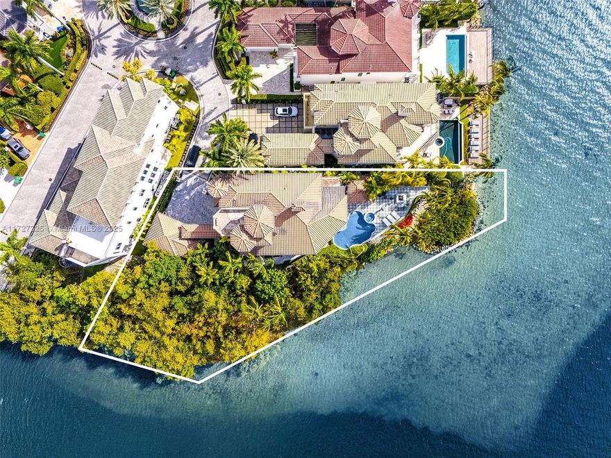 Experience unrivaled luxury on the open bay in the gated community of Island Estates. This rare home sits on one of only two double lots (24,772 sqft) with 240 ft of water frontage, offering the best views. Features include vaulted 30 ft ceilings, top finishes, a gourmet kitchen, elevator, and a luxurious master suite with veranda. Highlights are a tropical pool, spa, impact glass, 3 levels, a 2-car garage plus golf cart garage, and a private marina with boat slip. Adorned with 14K gold Swarovski chandeliers, this home combines elegance with advanced smart home system. Residents enjoy exclusive access to Prive’s five-star golf and tennis amenities.