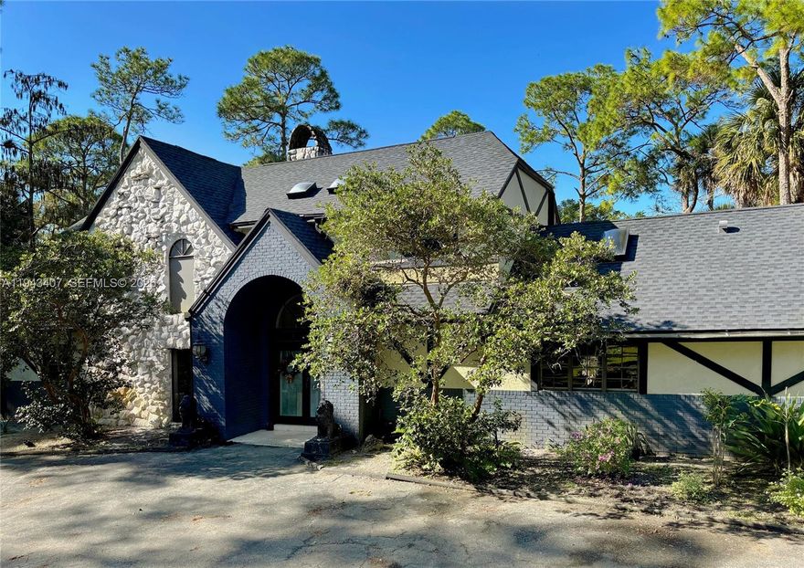 A rare opportunity for luxury acreage living in Palm Beach County, this distinctive Tudor-style estate delivers privacy, architectural character, lifestyle flexibility, and built-in income potential within the Fox Trail Equestrian Community. Set on 5 serene acres surrounded by mature pines, this property delivers a refined rural feel while remaining minutes from Wellington. A fully renovated barn apt ideal for guests or passive rental income (proven $3500 per month).The main residence is filled with natural light from skylights and features soaring high ceilings. A striking stone wall fireplace anchors the living room beneath extra-high ceilings and opens directly to the pool, creating a seamless indoor-outdoor connection. The home features three master bedrooms with walk-in closets, including two upstairs and a downstairs one with direct pool access. A guest half bathroom adds convenience, along with a full outdoors bathroom serving the barn and pool areas. A separate family room provides flexible space for a home office, gym, media room or even an extra guest room. Attached 2 car garage. Outdoor living feels private and resort-like, with the pool framed by tropical landscaping and an extra large screen. A new roof with transferable warranty provides peace of mind. 
The property includes a barn with 3 existing stalls (12x9), a tack room, and plenty of space for paddocks or riding areas, offering true equestrian potential with access to 29 miles of private bridle trails.