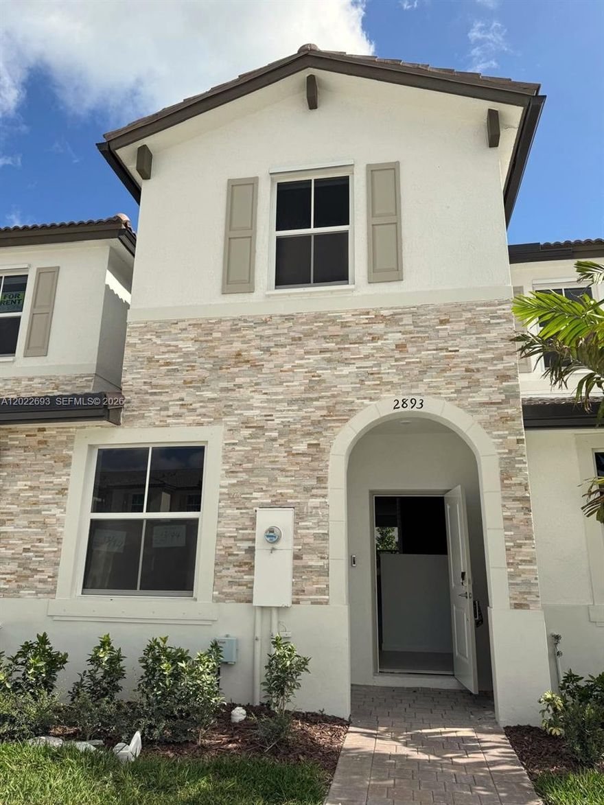 Brand-new three-bedroom, two-bathroom turnkey townhouse in the gated community of Altamira, the first golf-course-centric residential community in Homestead, FL 33035. The open-concept main level flows seamlessly between living, dining, and kitchen areas, with a contemporary kitchen featuring stainless steel appliances, expansive countertops, and ample cabinetry storage for everyday use and entertaining. Upstairs, three generously sized bedrooms offer flexibility for a primary suite, home office, or guest accommodations, served by two full bathrooms with modern finishes throughout. As newly built construction, this Altamira townhome delivers updated mechanical systems, fresh finishes, and turnkey move-in condition without the renovation timeline of older inventory. Altamira residents enjoy resort-style amenities including a clubhouse with fitness center, community swimming pool, tennis courts, BBQ areas, a scenic lake, landscaped parks, and dedicated outdoor recreation paths set within a gated suburban-style setting. The 33035 location offers convenient access to Homestead-Miami Speedway, Keys Gate Tennis Club, regional shopping and dining, the Florida Turnpike, and US-1, providing quick reach to the Florida Keys, Everglades National Park, Biscayne National Park, downtown Miami, and Miami International Airport. A compelling combination of brand-new turnkey construction, gated community access, golf course amenities, and Homestead, FL 33035 location.