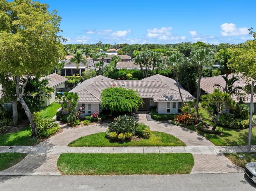 Beautifully updated 4BD/2BA home featuring marble floors in main areas and wood floors in all bedrooms. Gourmet kitchen with wood cabinetry, mosaic backsplash, granite counters, wine cooler, center island, and premium stainless appliances incl. oversized fridge, grill, and double oven. Primary suite offers walk-in closet, remote shades, and spa-like bath with steam shower, bidet, and Culligan system. Outdoor oasis boasts heated saltwater pool, spa, putting green, covered patio with TV, and 25 palm trees. A mix of hurricane doors, impact windows & shutters, tankless water heater, 5-ton A/C (2022), Nest system, and more. MOTIVATED SELLERS & a must-see!