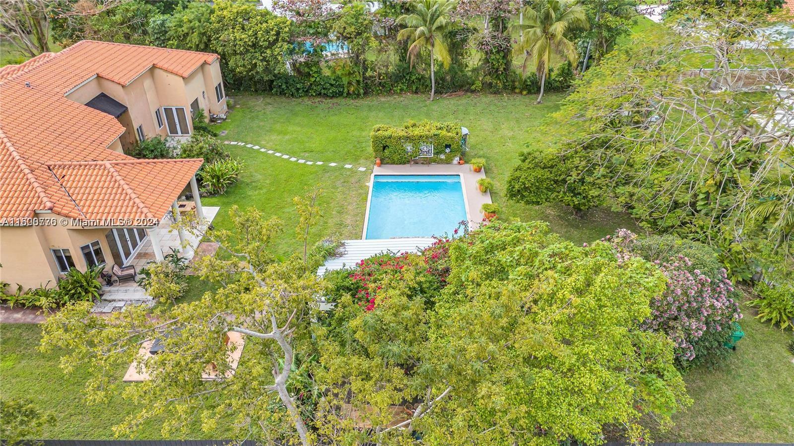 East Kendall hidden masterpiece! Nestled on a quiet dead end street, this estate offers over 33K square foot lot and almost 4500 square feet of glorious living space. Beautiful curb appeal continues into a formal foyer entrance. Impressive 17 foot ceilings throughout the home allow tons of natural light throughout, enhancing the beautiful architecture & archways. Perfect for art lovers! Layout provides a formal dining, living plus a huge family room, den and eat in kitchen. Expansive primary suite is tucked away and features enormous closets and cozy sitting area overlooking the Koi pond. Secondary bedrooms are all ensuite and spacious. The property is adorned with lushly landscaped grounds, oversized pool, Bougainvillea draped gazebo and aviary. Excellent location! Original owner!