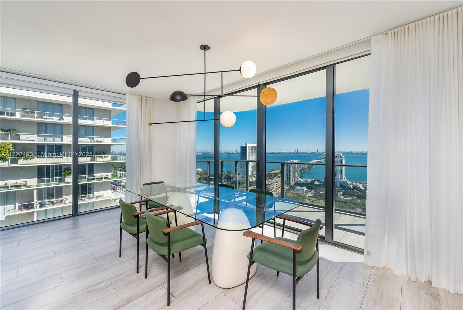 Gorgeous furnished high floor 3 bed 3.5 bath designer corner unit with amazing views of Biscayne Bay and Miami Beach from large balcony. Top of the line European kitchen, floor to ceiling windows, designer wallpaper, luxury high-end finishes and fixtures, custom window treatments, and California Closets. Retreat to the main suite with dual vanity ensuite bath, separate from the two spacious ensuite guest rooms. Separate residence entrance and 24 hour securityTennis courts, fitness center, spa, putting green, business center, media room, and kids rooms. Close proximity to Design District, Wynwood, Miami Beach, and Miami airport.