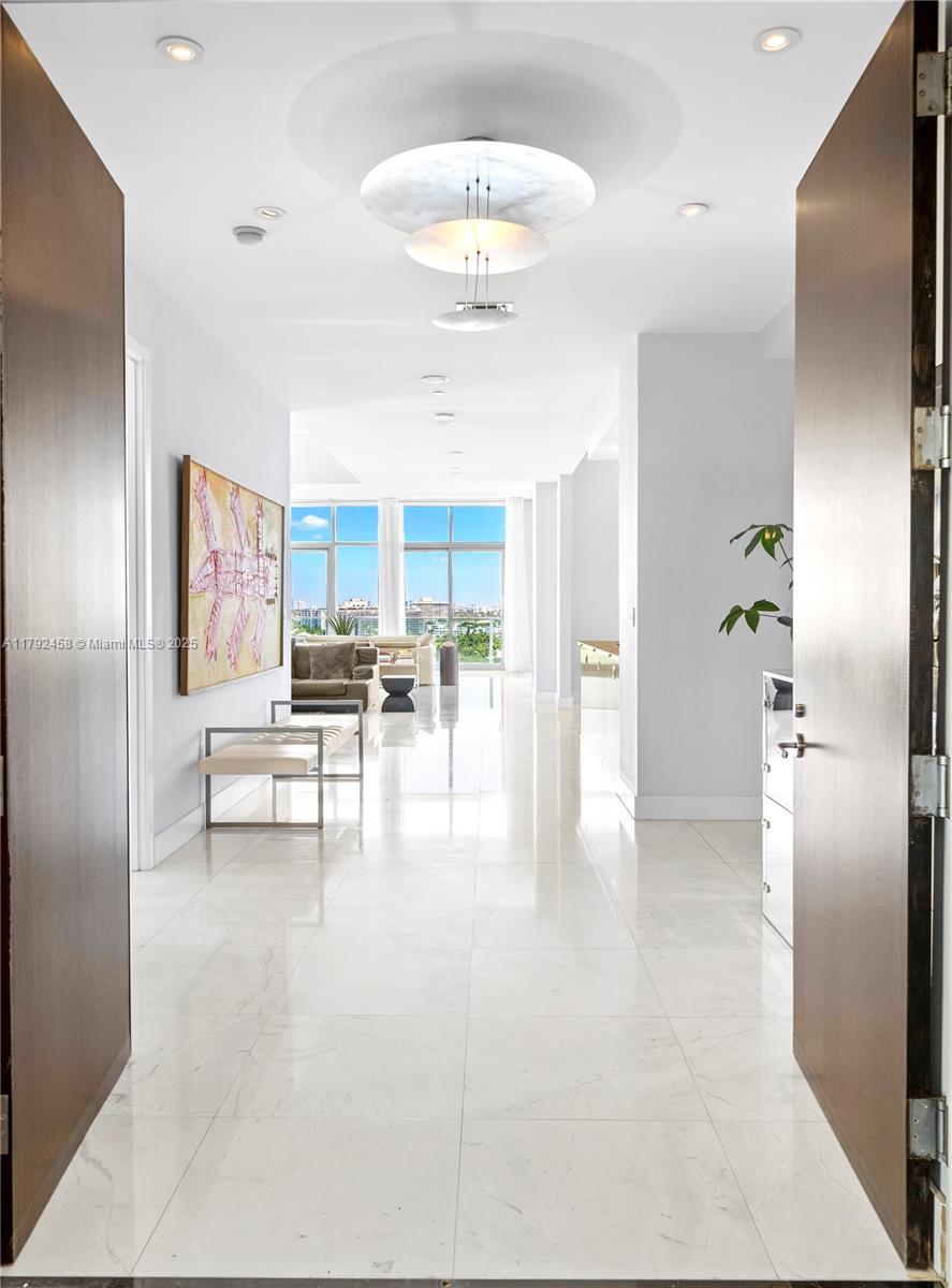 Undeniably the best residence at Aqua, the 1001 is a stunning, sun-lit lower penthouse where modern luxury meets breathtaking views. 3,321 SF of elegant living space plus 420 SF of wrap-around terraces. This 3-bedroom and 3.5-bathroom residence boasts soaring 14-foot ceilings, expansive walls of glass, and an open, airy ambiance that invites natural light to fill every corner. Enjoy sweeping views of the iconic Miami skyline, ocean, and Intracoastal from every room. Featuring bright and extremely spacious living areas, marble floors, and sophisticated furnishings. Three parking spots. Two large dogs are allowed.
Aqua Allison Island is an exclusive 8.5-acre private island community with world-class amenities set amidst lush gardens. In the heart of Miami Beach, steps away from the beach.