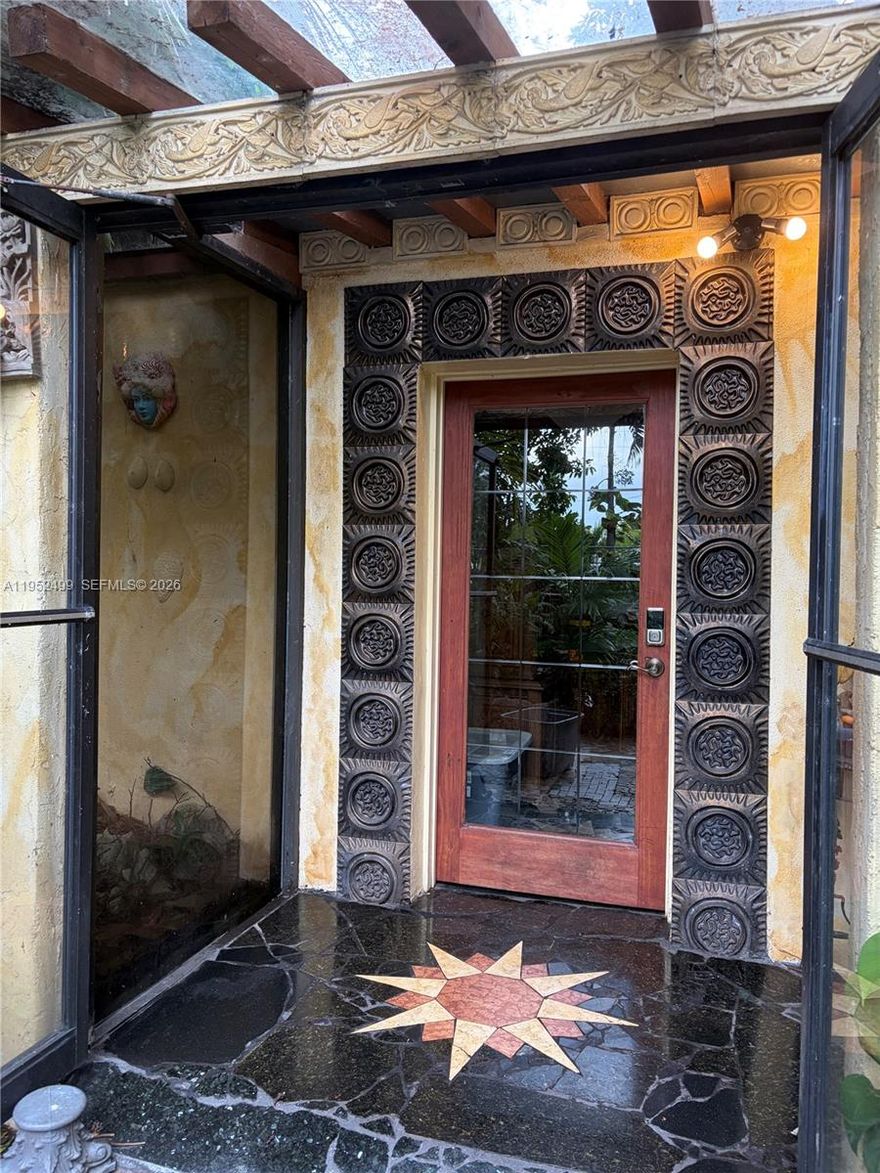 19,454 sf DOUBLE lot (just under half an acre) 3/2 House first time listed since 1975. Folio 494222080930 main house plus Folio 494222080920 additional lot with concrete pad and vintage trolley (included). On a dead-end street, this "Garden of Eden" has privacy fencing on all neighboring lots. Water features include an outdoor pond and fountain plus an orchid atrium. Hundreds of tropical palms and edible plants collected from around the world. Paths wind through foliage to a raised deck nestled under the trees, complete with a large gazebo. Excellent for outdoor entertaining, this home includes an enclosed patio, granite and marble floors, huge closets, iron gates, fireplace, river rock features, open beam ceiling, picture windows, tiki hut, river rock pizza oven/grille, and a solarium.