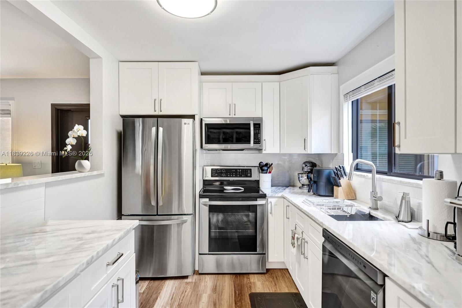 Charming and fully furnished 2 bed / 2 bath condo in the sought-after Lakes of Delray 55+ gated community. This upgraded CBS-constructed unit features stainless steel appliances (2020), A/C (2020), water heater (2020), and a full remodel completed in 2020. Enjoy marble countertops in the kitchen and bathrooms, stylish laminate flooring throughout, and impact windows and sliding doors for peace of mind. The front door has been upgraded for added curb appeal. Roof replaced in 2019. Screened-in patio with serene views, assigned parking right in front of the unit, plus plenty of guest parking. Community amenities include clubhouse, pool, spa, fitness center, tennis, bus service, and a full social calendar. Just minutes from the beach and vibrant Atlantic Ave!!!