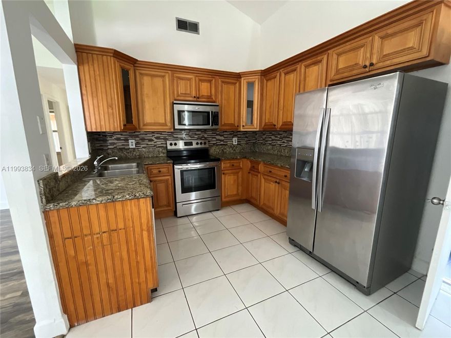 Welcome to this beautiful and spacious home nestled in a highly desirable, family-friendly Miramar neighborhood. Designed with comfort and functionality in mind, this residence offers an open and airy layout perfect for both everyday living and entertaining.

Step inside to find stylish laminate flooring flowing throughout the main living areas, adding warmth and modern appeal. The generous living spaces provide plenty of room for gatherings, while large windows invite in natural light, creating a bright and welcoming atmosphere.

The home features a well-appointed kitchen and ample bedroom space, ideal for growing families or those who love extra room to spread out. Outside, you'll discover a huge backyard—perfect for kids, pets, weekend barbecues, or even creating your dream outdoor oasis.

Located in a safe and friendly community close to schools, parks, shopping, and dining, this home truly has it all. Don’t miss the opportunity to make this spacious gem your own!