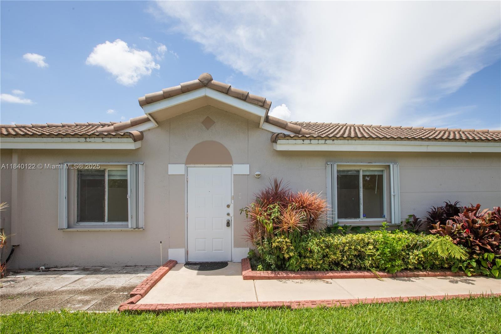 Welcome to this charming traditional 3-bedroom, 2-bathroom villa, perfectly nestled within a highly sought-after gated community in Miramar, a corner unit. Enjoy the best of South Florida living with the convenience of being just minutes from major arteries like I-75 and the Florida Turnpike, offering unparalleled access to shopping, dining, and effortless commutes. This delightful home offers a serene retreat with picturesque lake views that can be savored from your very own spacious screened patio. Imagine starting your mornings with a cup of coffee overlooking the shimmering water or winding down evenings in a private, insect-free oasis, perfect for entertaining or quiet relaxation.
