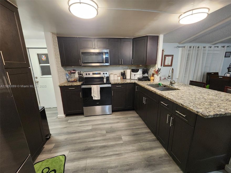 Come see this amazing opportunity to own a mobile home where you own the land.  All ages welcome! Kitchen with stainless steel appliances, walk in closets, floors and baths have been remodeled. Roof was redone March 2021. Low HOA at $103 monthly. Property can be rented. Property has covered parking space and yard that has no neighbors behind. There is a community pool, basketball court and gym. Centralized and close to A schools like Chapel trail elementary, Silver trail middle and West Broward High.